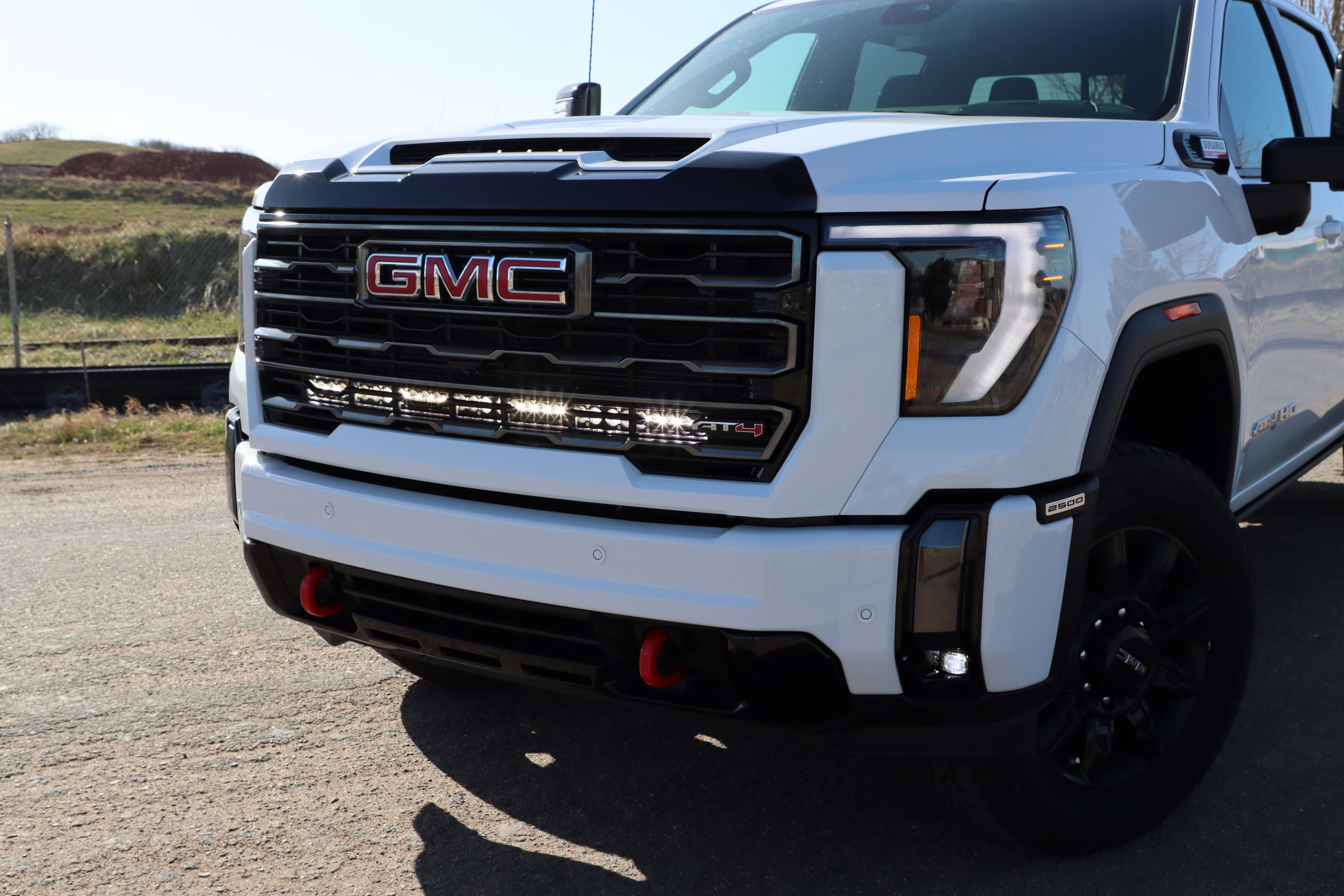 behind the grille light bar mount for HD Chevy truck